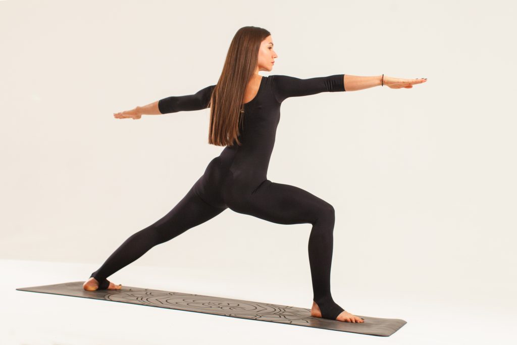 A woman while doing the warrior yoga pose 