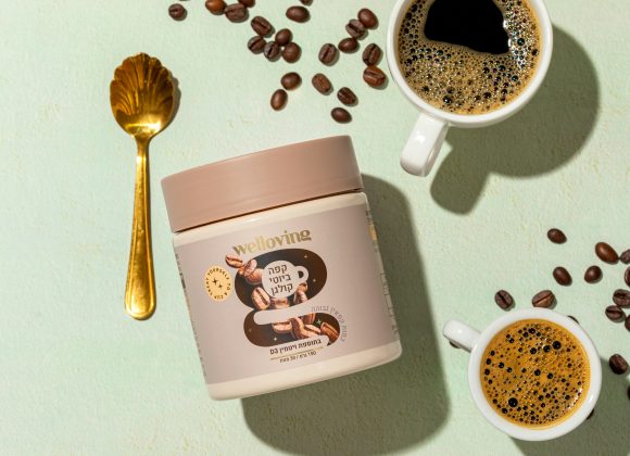 Two cups of coffee, scattered coffee beans, and collagen powder.