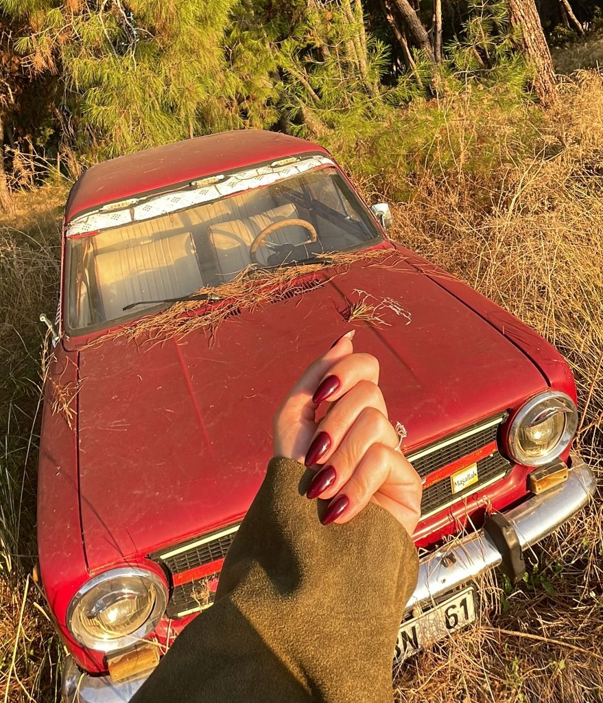 Close-up of a woman’s hands with wine-red nail polish for an easy winter nail.