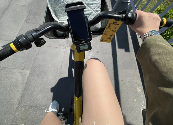 Cycling and biking on a blue coastal bike lane in Antalya with sea views, and city buildings under a bright sky.