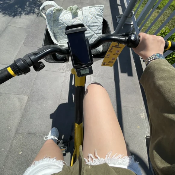 Cycling and biking on a blue coastal bike lane in Antalya with sea views, and city buildings under a bright sky.