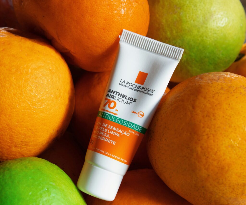 Best sunscreen product surrounded by fresh citrus fruits, highlighting bright skincare protection and healthy glowing skin.