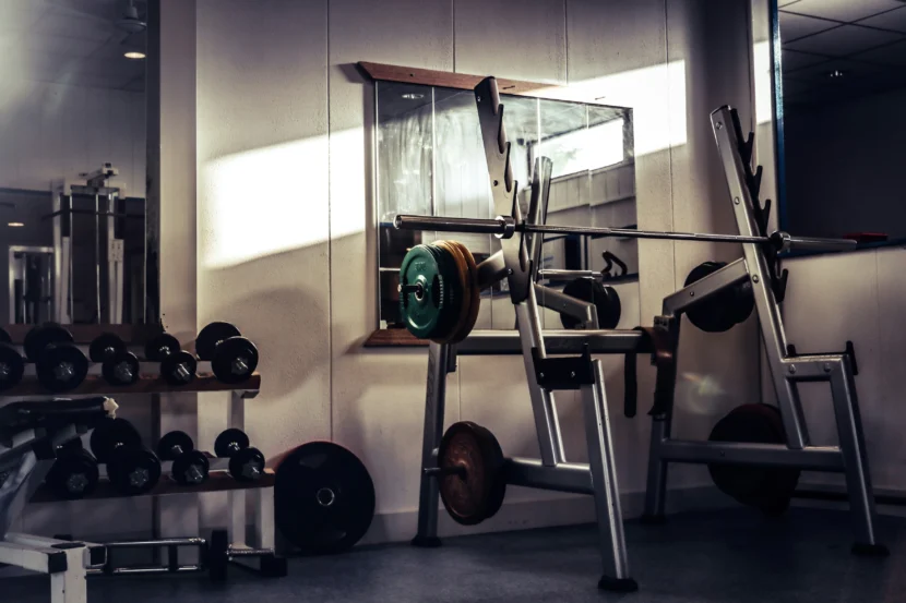 Beginner gym routine in a modern gym salon with workout equipment and strength training machines.
