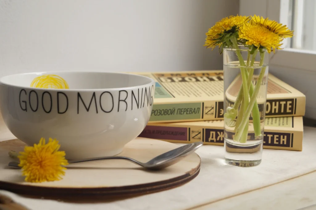     Cozy summer morning routine featuring a healthy breakfast and fresh flowers in natural sunlight.