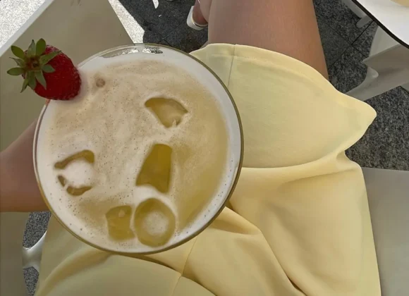 Easy cocktail recipes at home featuring a creamy tropical Piña Colada with ice and fresh strawberry garnish