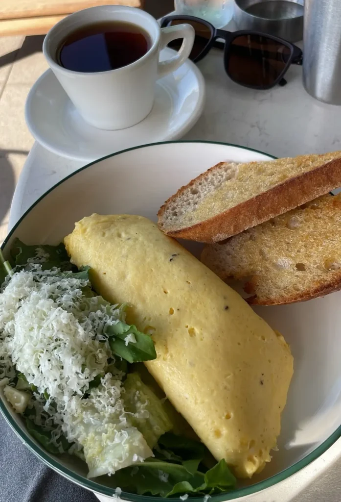 - Breakfast in Antalya at Walker’s Coffee with a fluffy omelet, toasted bread, fresh greens, cheese and a warm cup of tea.