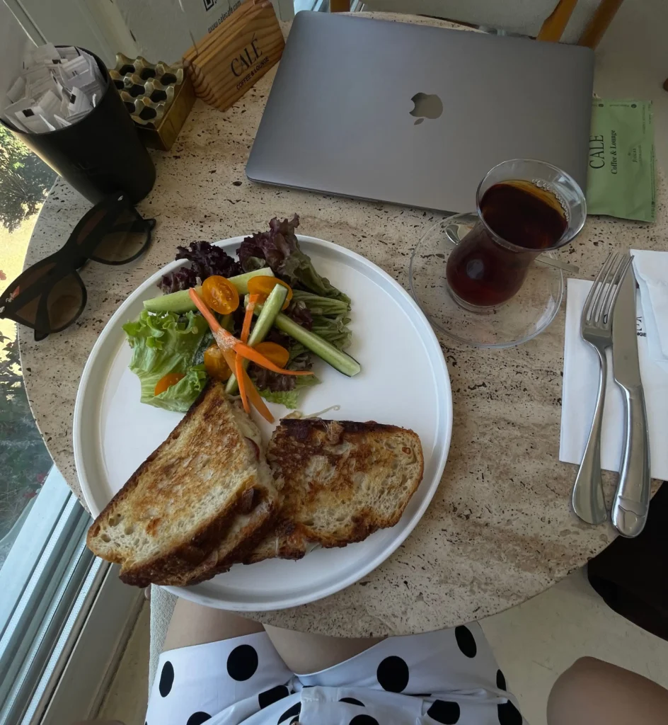 Breakfast in Antalya at CALE Café with toasted sourdough, fresh salad and Turkish tea in a relaxed café setting.