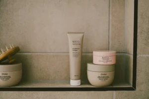 Skincare and hair care products arranged on a bathroom shelf for a relaxing Sunday reset routine focused on self-care and beauty.